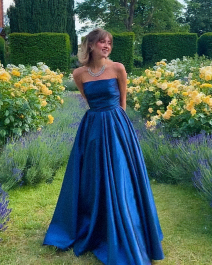 Young woman in a blue gown standing in garden, related to anti-vax refusal of chemotherapy news story.