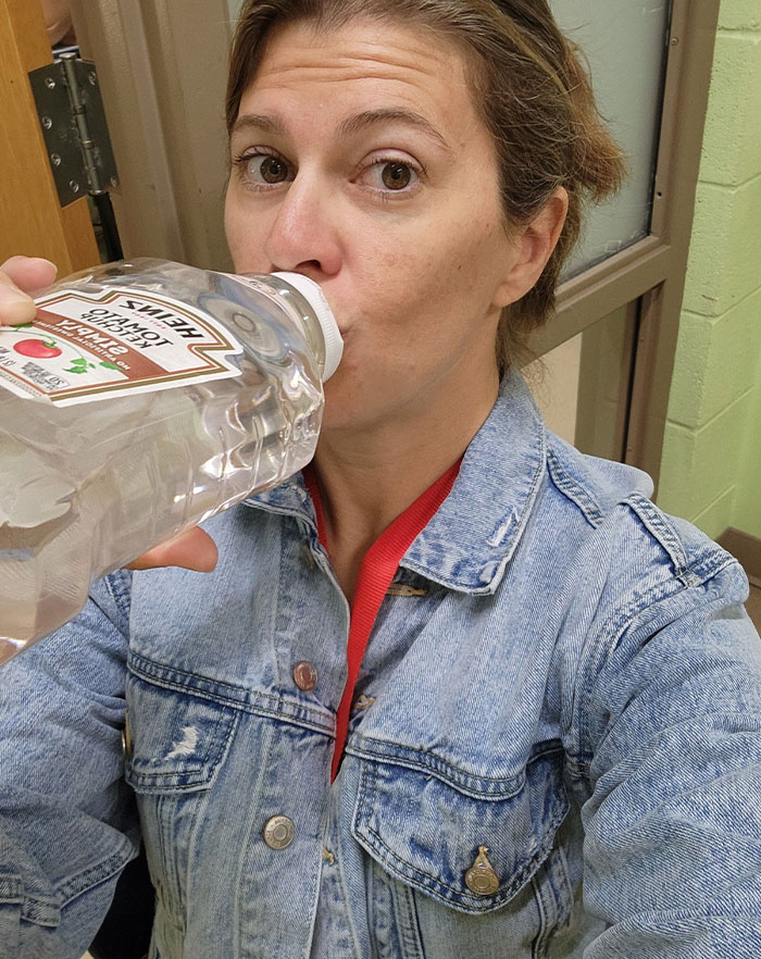 Woman wearing denim jacket drinking from a tomato sauce container showcasing creative sippers who drink from anything but a cup