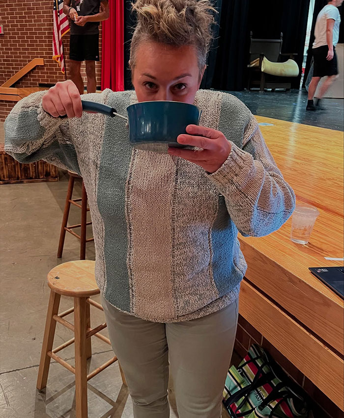 Person drinking from a pot handle, showing creative sippers who chose to drink from anything but a cup.