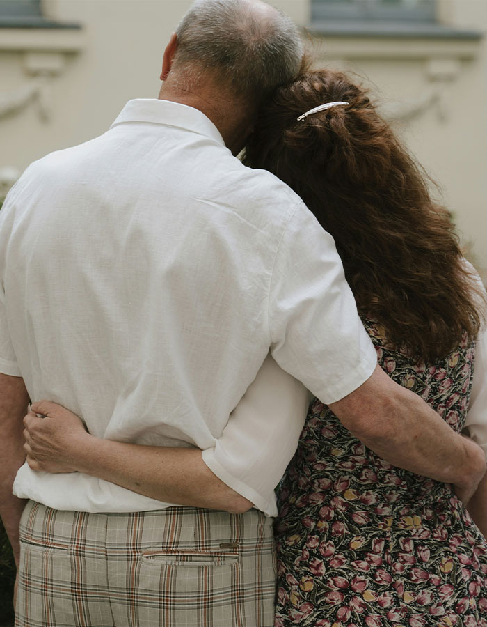 Middle-aged couple hugging outdoors, symbolizing supportive parents in an OnlyFans star's x-rated career journey.