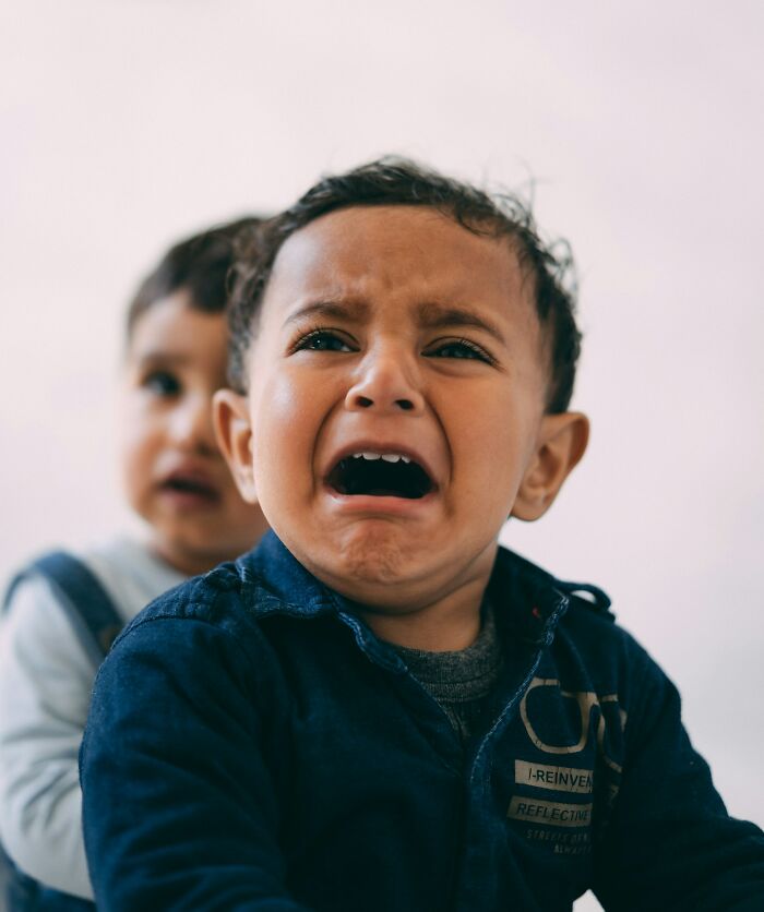 Crying toddler boy showing distress, highlighting emotional impact of parents punishing their kids way too far.