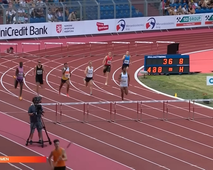 Sprinters competing in a 400m hurdles race on an outdoor track during a viral viral sprinter event. Sprinters competing in a 400m hurdles race on an outdoor track during a viral viral sprinter event.