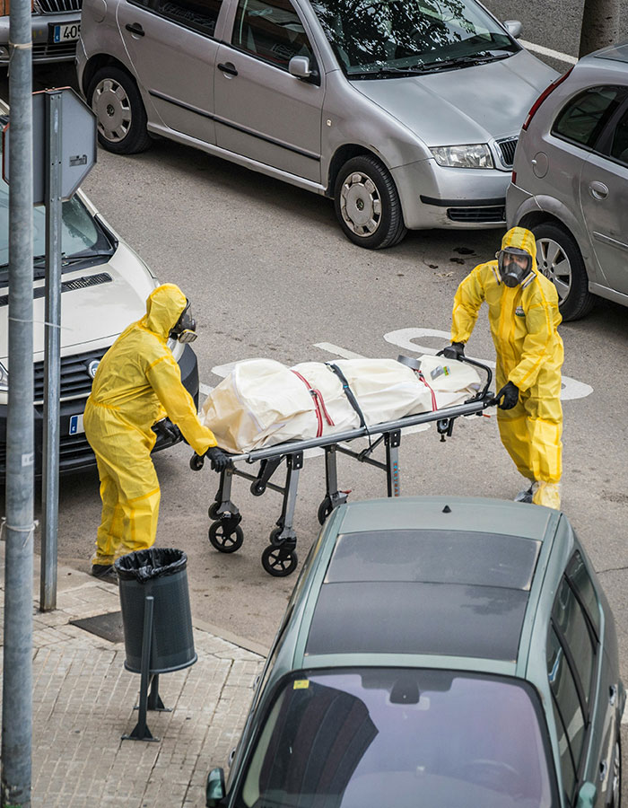 Two workers in hazmat suits transporting a body bag on a stretcher highlighting unusual ways people have passed away.