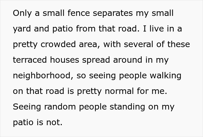 Small fence separating patio from road in crowded neighborhood, with people walking nearby, highlighting a man's autism experience.