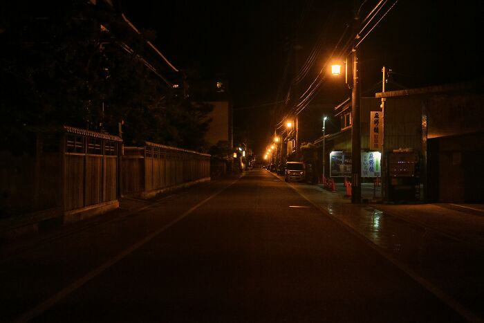 Empty street at night illuminated by streetlights, representing the experience of night shift workers overnight. - 4