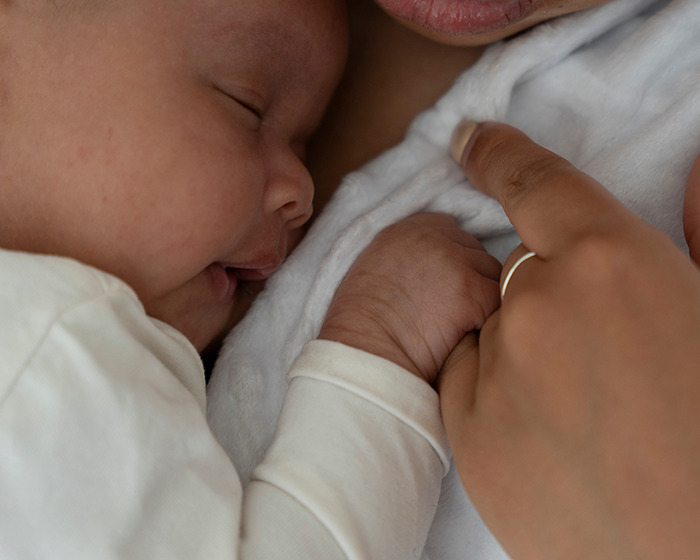 Sleeping baby girl resting on father's chest during skin-to-skin contact highlighting baby girl develops micropenis concept. - 3