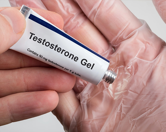 Tube of testosterone gel being squeezed onto a gloved hand relating to baby girl develops micropenis case - 4