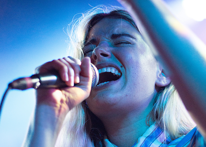 Teen singing passionately into microphone under stage lighting, reflecting the stepmom bans teen family dinners topic. Teen singing passionately into microphone under stage lighting, reflecting the stepmom bans teen family dinners topic.