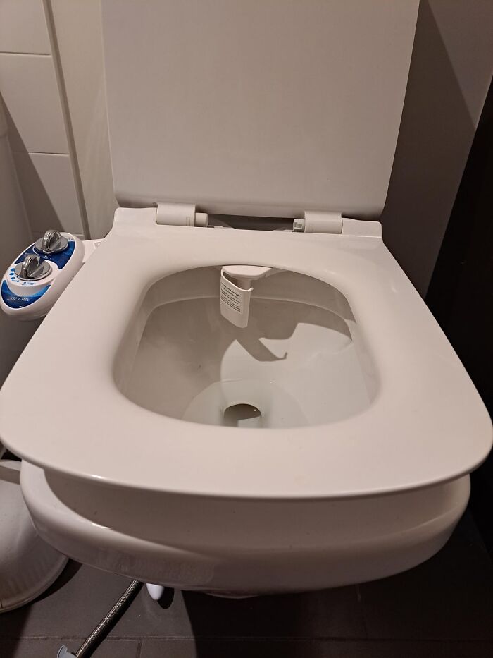 Close-up of a modern white bidet toilet seat showing controls, highlighting people share things improved life comfort. - 29