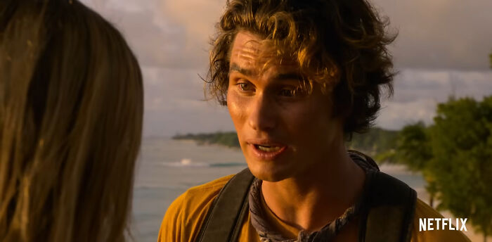 Young man talking to a woman near the beach, representing best Netflix shows that keep viewers coming back for more. - 21