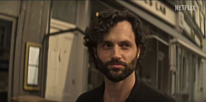 Man with curly hair and beard standing outside, scene from one of the best Netflix shows that keep viewers hooked. - 13