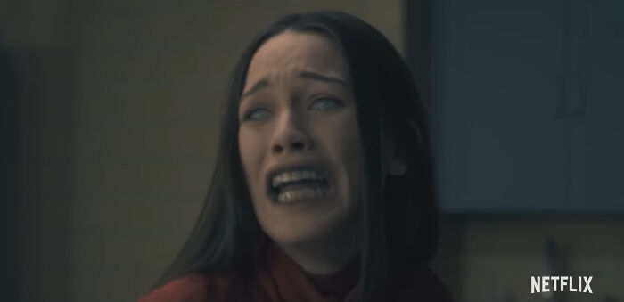 Woman with long dark hair looking terrified in a dramatic scene from one of the best Netflix shows keeping viewers hooked. - 3