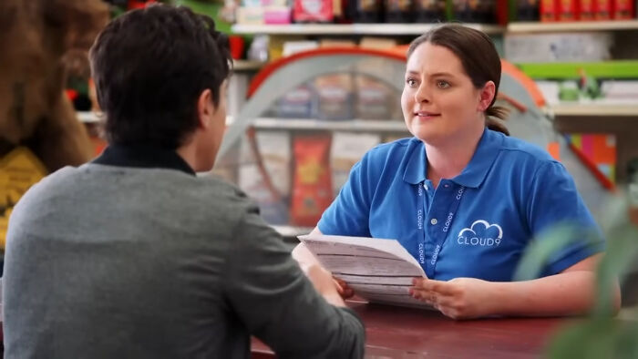 Two people in a casual discussion at a counter, highlighting the best Netflix shows that keep viewers coming back for more. - 11