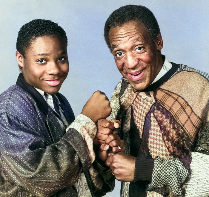Bill Cosby and Malcolm-Jamal Warner posing together, wearing patterned sweaters, sharing a cheerful moment. - 4