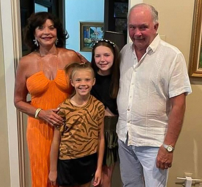Family portrait of two sisters and their relatives standing indoors, related to Texas floods and sisters who lost their lives.