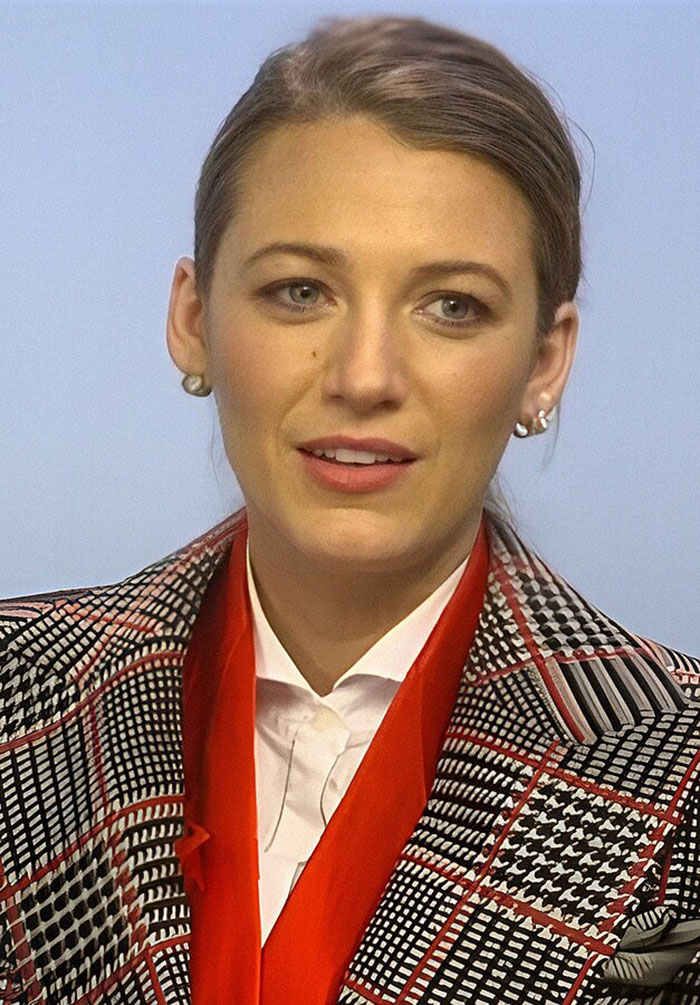 Blake Lively wearing patterned jacket and red scarf, reacting during court appearance after reality check from judge - 7