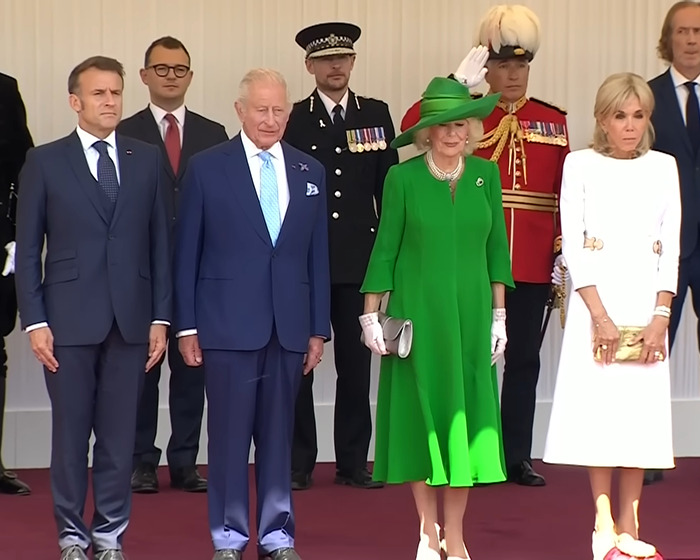 Brigitte Macron's cold behavior towards husband captured during UK visit with formal group and dignitaries present.