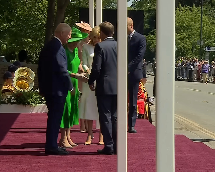 Brigitte Macron exhibiting cold behavior towards husband Emmanuel Macron during official UK visit greeting event.