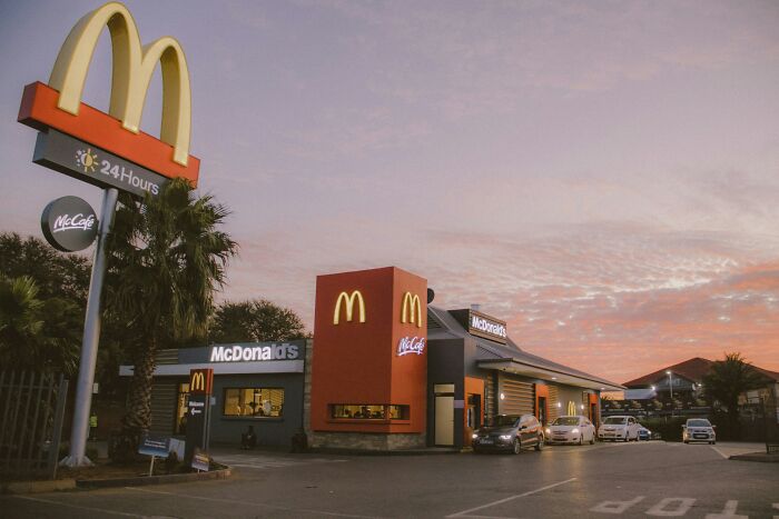 McDonald's restaurant lit at dusk in Singapore, relating to experienced mass panic over shrinking genitals topic.