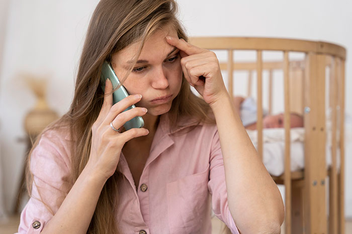 Young woman looking stressed while talking on the phone, reflecting on realizing friends are total jerks.