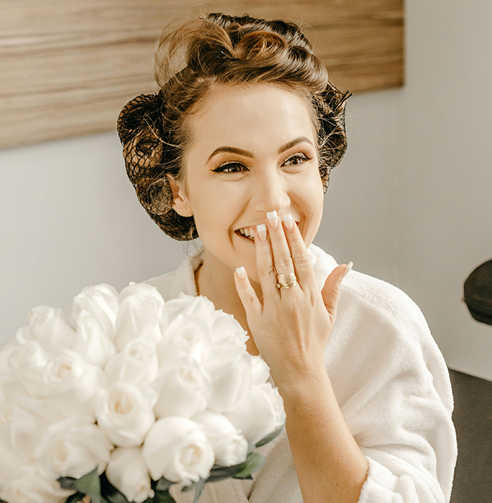 Bride smiling with white roses, celebrating a body positive wedding with a plus-size Weight Watchers table arrangement. Bride smiling with white roses, celebrating a body positive wedding with a plus-size Weight Watchers table arrangement.