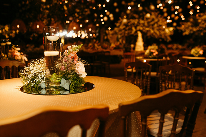 Wedding reception table with floral centerpiece and candles, highlighting a body positive plus-size seating arrangement. Wedding reception table with floral centerpiece and candles, highlighting a body positive plus-size seating arrangement.