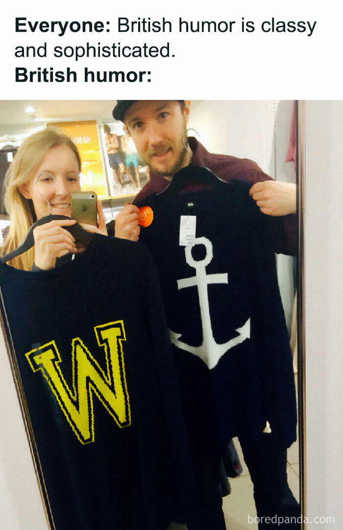 Two people holding novelty sweaters with W and anchor symbols, illustrating funny memes about life in the UK.