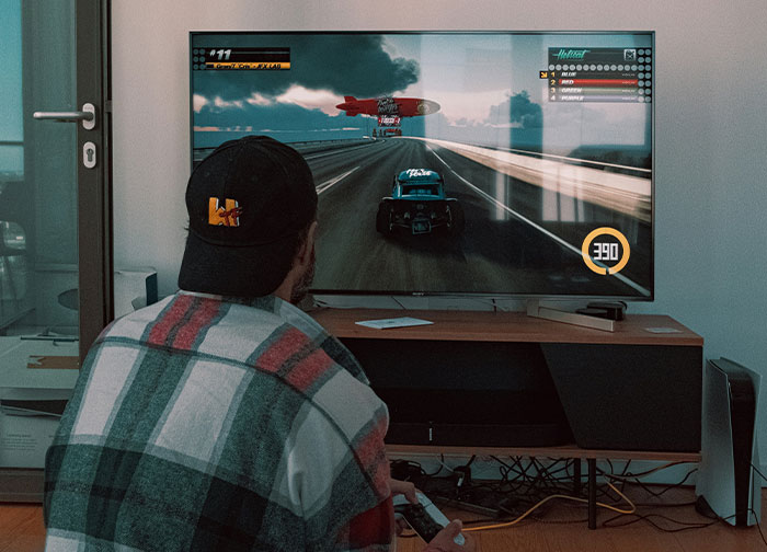 Man playing video games indoors, illustrating men get brutally honest and share what they never tell women feelings. - 42