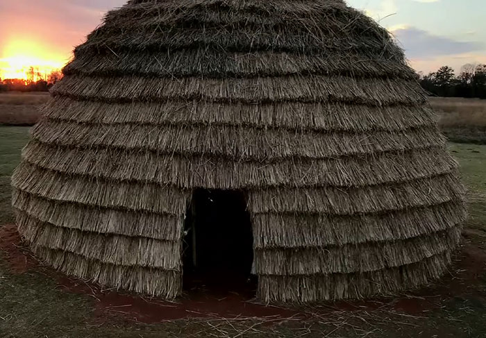 Traditional Native American thatched hut at sunset, symbolizing ancient culture and language risks extinction. - 15