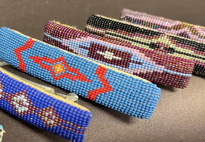 Colorful Native American beaded bracelets displayed on a table, representing cultural heritage and language risks. - 17