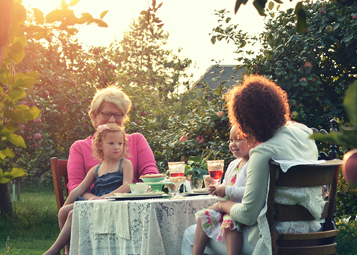 Family enjoying tea outdoors in a garden, highlighting a call off wedding weird family tradition gathering.