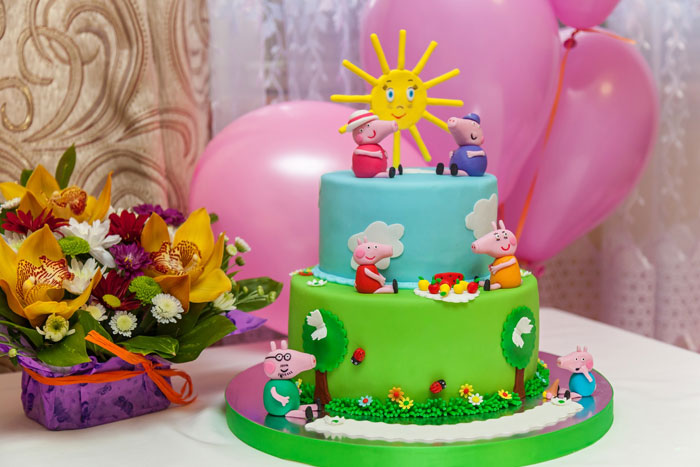 Colorful kids party cake with cartoon characters and decorations, related to sister and aunt party drama over cake payment. - 14