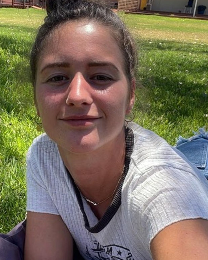 Young woman outdoors on grass, representing a backpacker who went missing in the Australian outback and was later found.