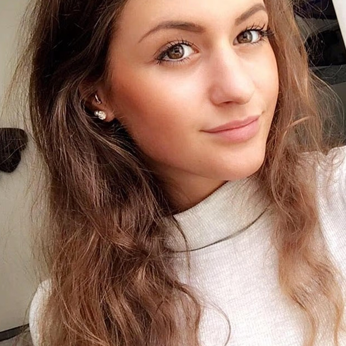 Young woman with long hair wearing a white top, representing the backpacker found after going missing in Australian outback.