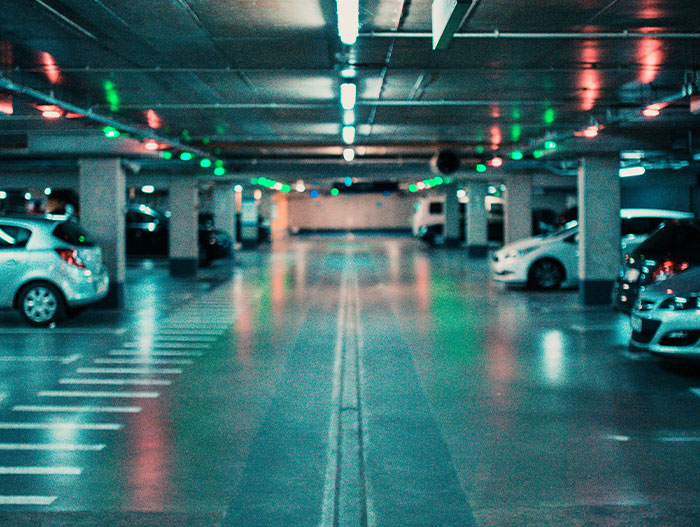 Underground parking garage with parked cars, illustrating a setting related to casino workers sharing stories.