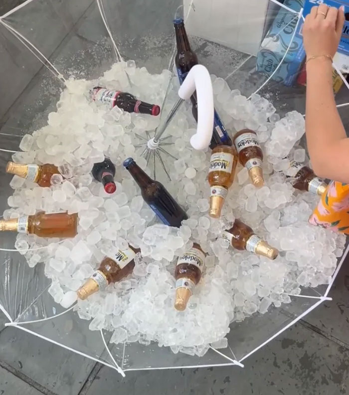 Clear umbrella filled with ice and beer bottles, illustrating a bride's wedding caterers mix-up before the ceremony.