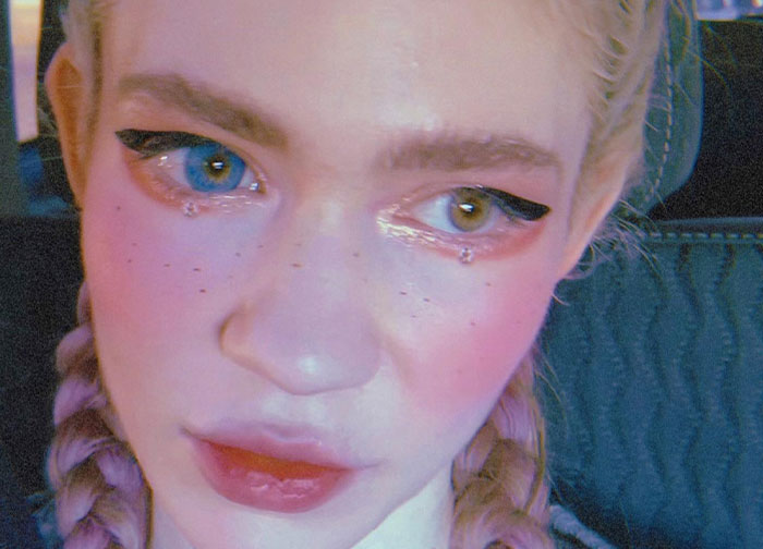 Close-up of a person with heterochromia and bold makeup, illustrating men’s wild things celebrities do after a breakup. - 12