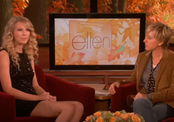 Taylor Swift and Ellen DeGeneres seated in a TV studio discussing celebrity breakups and therapy avoidance. - 15