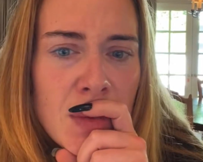 Close-up of a woman with blonde hair and blue eyes, appearing thoughtful and anxious, highlighting celebrity breakup reactions. - 19