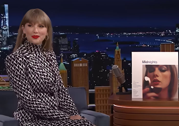 Female celebrity in patterned dress on a late-night show set, discussing wild things celebrities have done after breakup. - 20