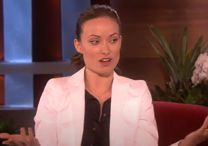 Actress in a white blazer sharing wild celebrity breakup stories during a candid television interview segment. - 24