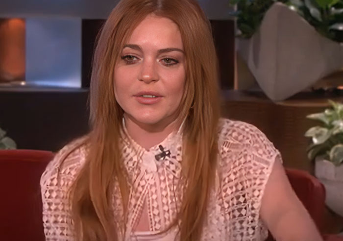 Actress with long red hair in a pink lace blouse sharing stories about wild things celebrities do after a breakup. - 29