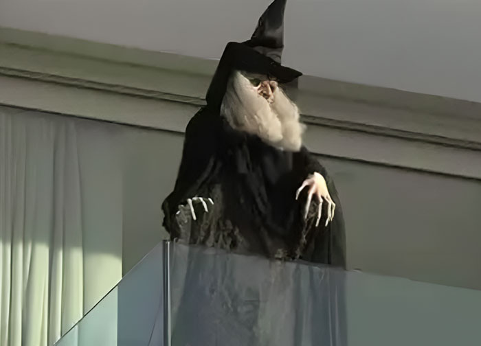 Witch costume on balcony with long white beard and black hat, illustrating wild things celebrities have done after breakup - 14