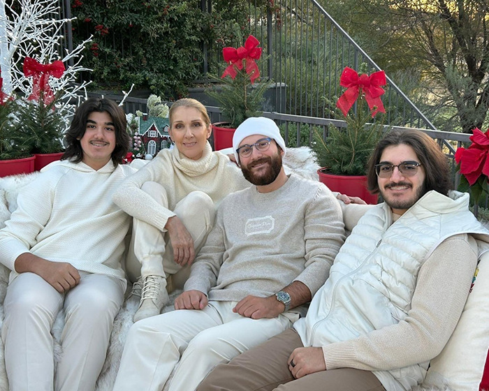 Céline Dion with family outdoors during holiday season, surrounded by festive decorations and red bows. - 7