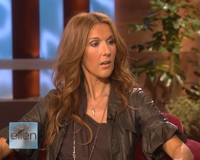 Céline Dion appearing surprised during a televised interview on the Ellen DeGeneres show set with plants in the background - 2