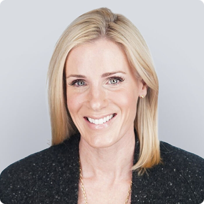 Blonde woman smiling in professional headshot, related to CEO and HR chief amid Coldplay scandal discussions.