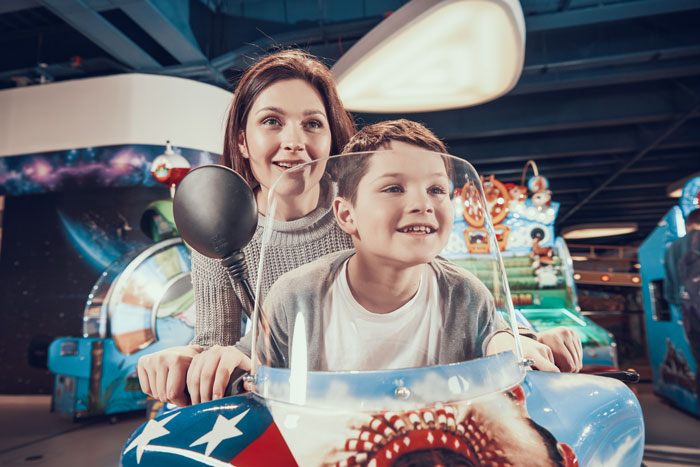 Mom and son enjoying arcade ride together, highlighting a mom clapping back at ex’s family with screenshots. - 10