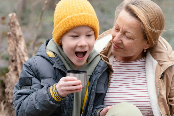 Mom claps back at ex’s family as child and woman share a joyful moment outdoors in casual fall clothing. - 20