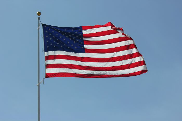American flag waving on a clear day representing iconic symbols in crazy but real historical events