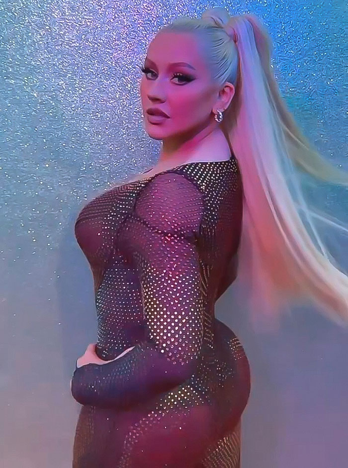 Christina Aguilera posing in a sheer, sparkly outfit during a photoshoot fueling Ozempic rumors. - 3